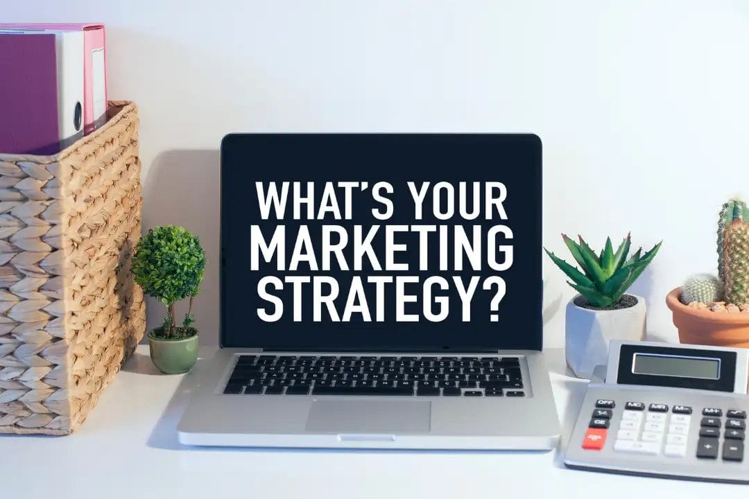 Laptop displaying text 'What's Your Marketing Strategy?'