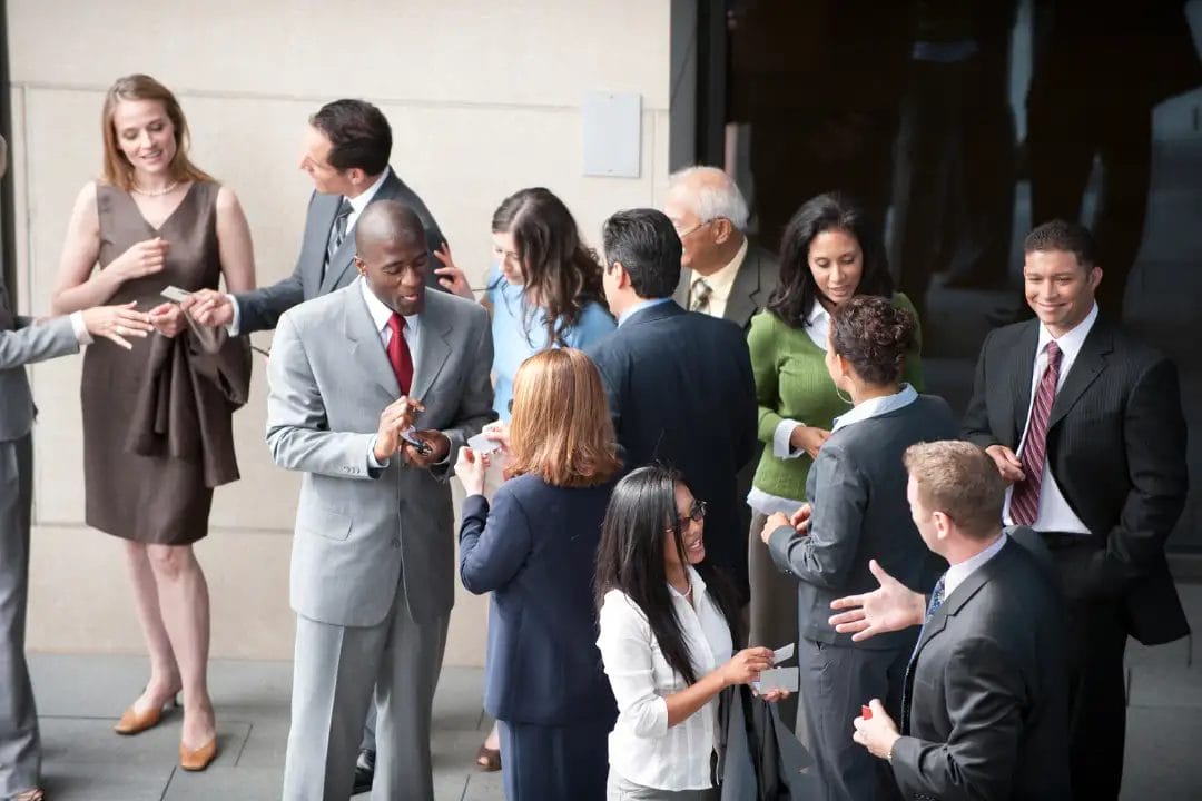 Diverse group networking at business event.