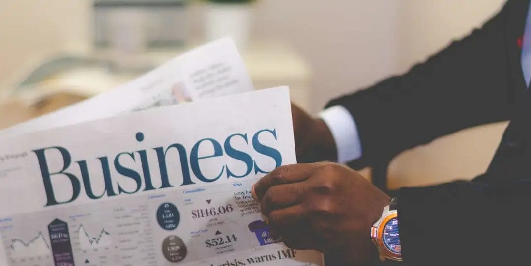 Person reading business newspaper.