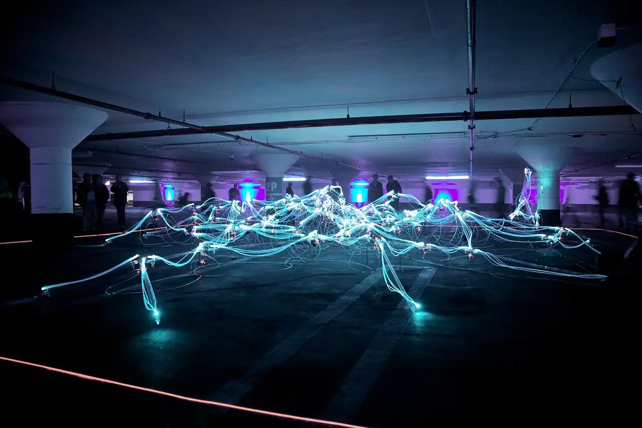 Underground LED light art installation in dim garage