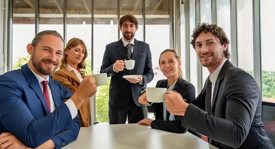 Business team enjoying coffee meeting in office.