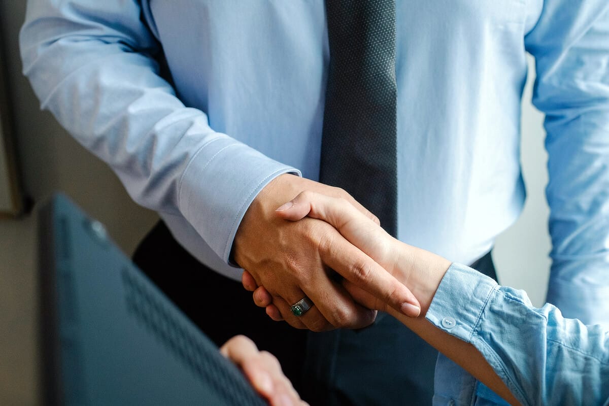 Two people shaking hands professionally.