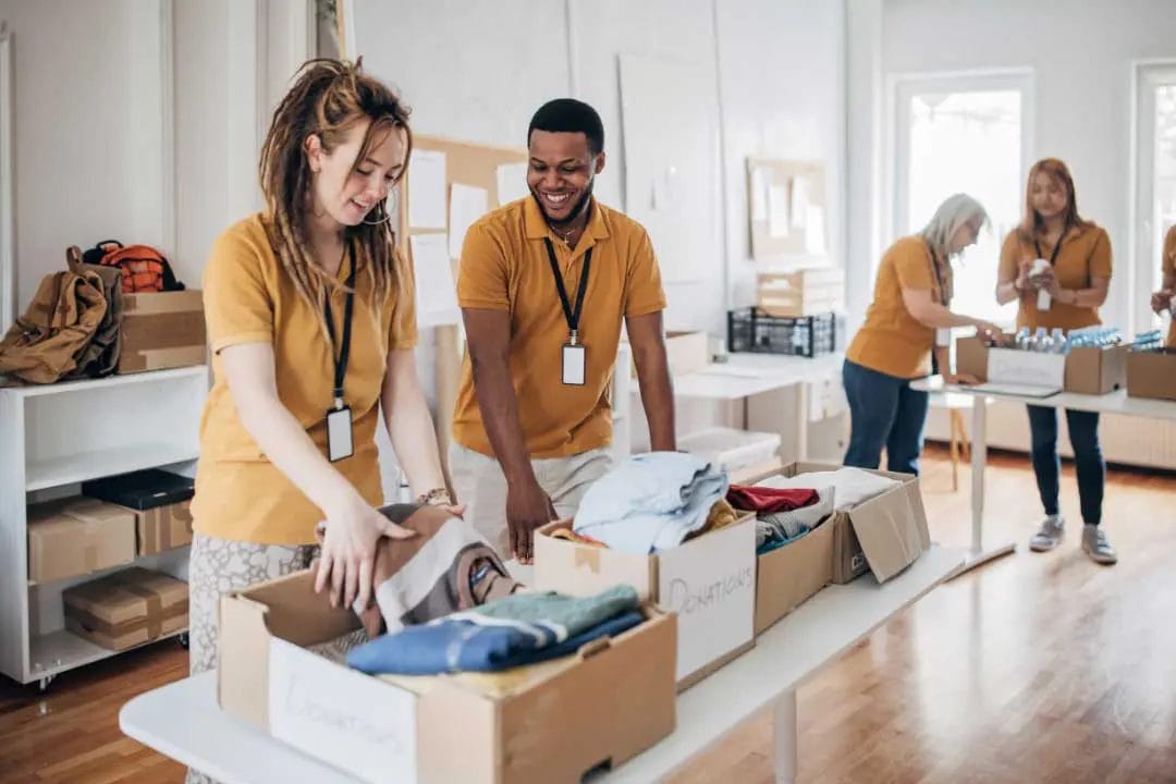 Volunteers sorting donations in a community centre.