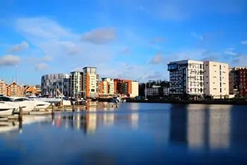 Ipswich Waterfront with modern buildings and moored boats.