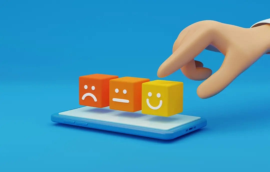 Hand selecting emoji from phone screen