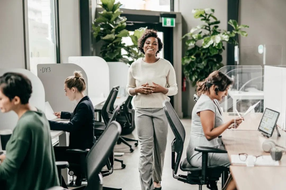 Woman walking in modern office environment.