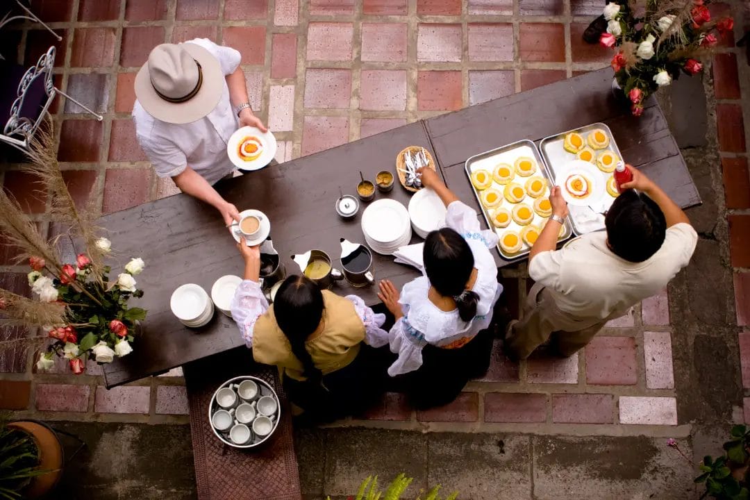 People serving food at an outdoor event.