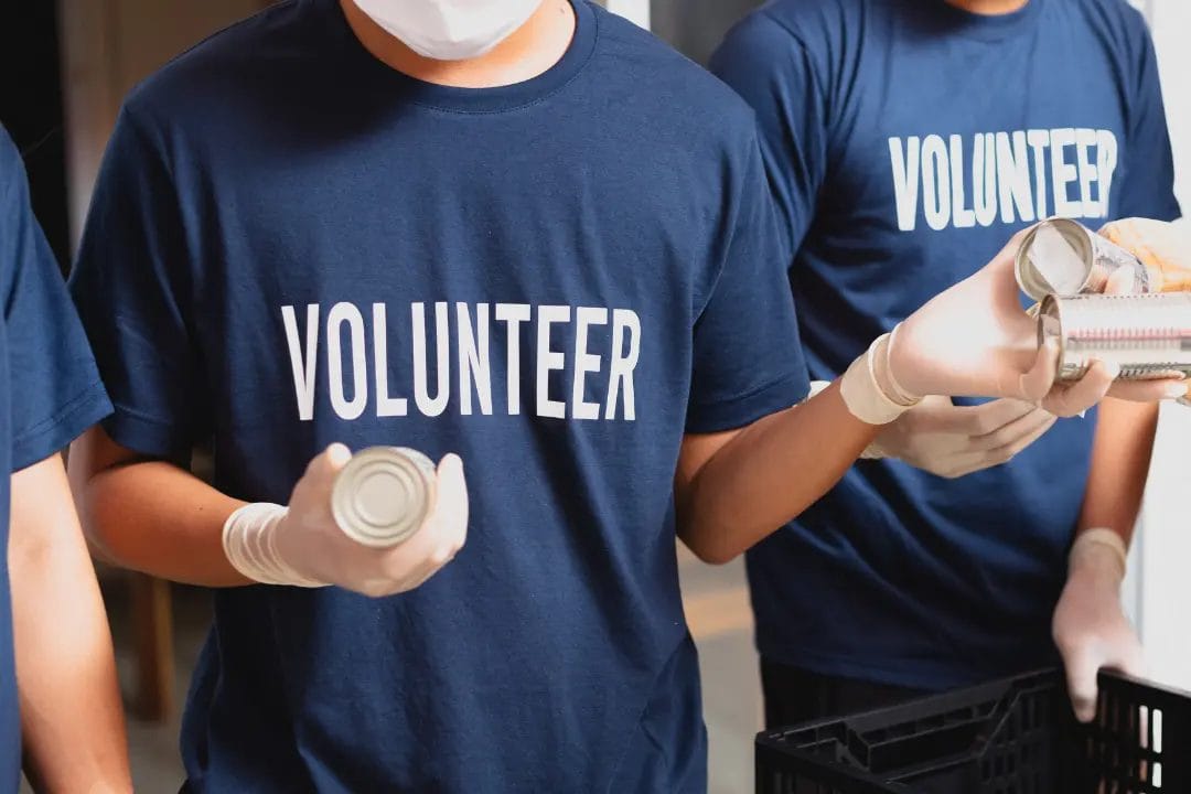Volunteers handling canned goods at donation centre.